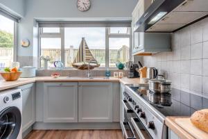 a kitchen with a sink and a stove top oven at 5 Bed in Beadnell oc-24955 in Beadnell