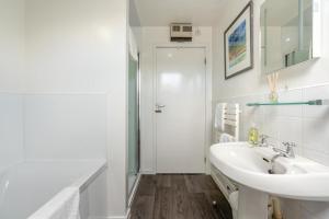 a white bathroom with a sink and a shower at 5 Bed in Beadnell oc-24955 in Beadnell +40 photos