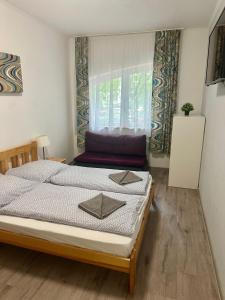 a bedroom with a bed with two napkins on it at Hullam Rooms Siofok in Siófok
