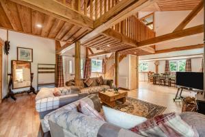 a living room with couches and a flat screen tv at 3 Bed in Chulmleigh oc-87779 in Eggesford