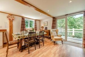a kitchen and dining room with a table and chairs at 3 Bed in Chulmleigh oc-87779 in Eggesford