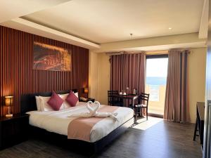 a bedroom with a bed and a desk and a window at Navarro Hotel in Caticlan