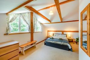 a bedroom with a bed and a desk and windows at 3 Bed in Chulmleigh oc-87779 in Eggesford