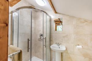 a bathroom with a shower and a sink at 3 Bed in Chulmleigh oc-87779 in Eggesford +40 photos