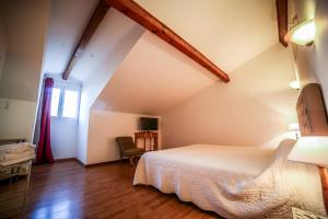 a bedroom with a white bed in a room at Castellu Rossu in Lucciana