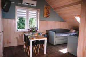 a small living room with a table and a couch at Pokoje Gościnne Sandomingo in Sandomierz