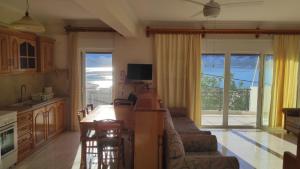 a kitchen and living room with a view of the ocean at Vasiliki Bay in Vasiliki