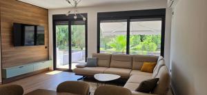 a living room with a couch and a tv at Villa Castro in Ulcinj