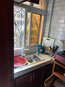 a kitchen with a sink and a window at Studio meublé akwa in Douala
