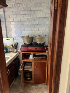 a kitchen with a stove with two pots on it at Studio meublé akwa in Douala