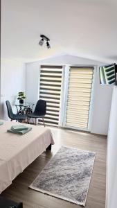 a bedroom with a bed and a table and chairs at Vraja din deal in Domneşti +58 photos
