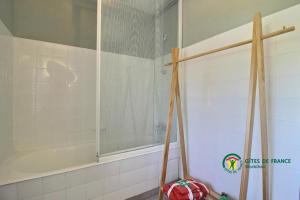 a shower with a glass door in a bathroom at La grée des dinosaures in Saint-Gravé +24 photos