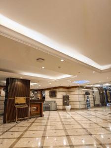 a lobby with a table and a counter in a building at Elite Jonrad Hotel LLC in Dubai