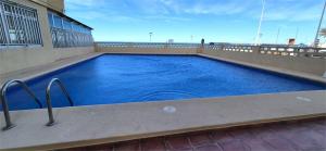 a swimming pool on the balcony of a building at Estudio playa in Bellreguart