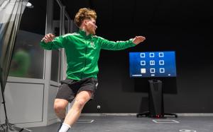 a man in a green shirt standing in front of a tv at Sportschule Oberhaching in Oberhaching +100 photos