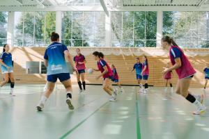 a group of girls playing a game of soccer at Sportschule Oberhaching in Oberhaching