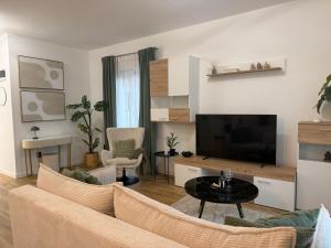 a living room with a couch and a tv at Sky Residence House in Cluj-Napoca