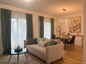 a living room with a couch and a table at Sky Residence House in Cluj-Napoca