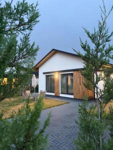 a cottage with a patio and a table and chairs at Sky Residence House in Cluj-Napoca