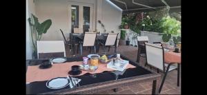 a table and chairs in a patio with a table and chairs at Bed and breakfast Nika in Rab