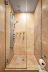 a shower with a glass door in a bathroom at Broadway Hotel in the Flatiron District in New York