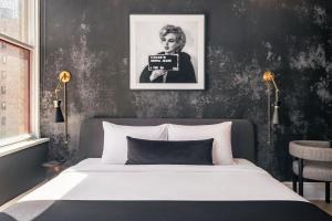 a bedroom with a bed with a black wall at Broadway Hotel in the Flatiron District in New York +39 photos