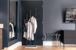 a room with hangers with white clothes on them at Broadway Hotel in the Flatiron District in New York