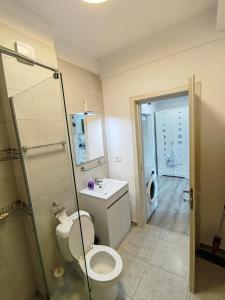 a bathroom with a toilet and a sink and a shower at MEM Studio in Mamaia Sat/Năvodari