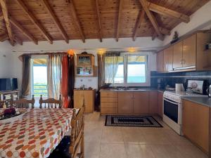 a kitchen with a table and a dining room at Akrojali in Kómboi