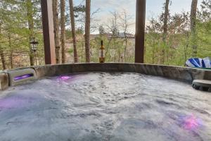 a hot tub with a bottle of wine in it at Living on the Ledge - Long-Range Mountain Views - Hot Tub and Fire Pit in Blue Ridge