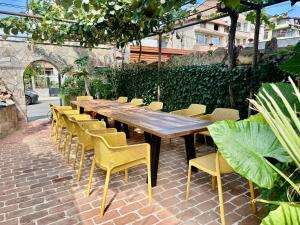 a wooden table and chairs in a patio at Къщата в Ахелой in Aheloy