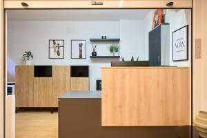 a kitchen with wooden cabinets and a counter at Hotel Centro Vitoria AutoCheckIn in Vitoria-Gasteiz