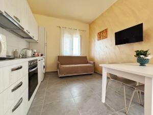 a kitchen with a table and a couch in a room at Villa Silla - Casa Vacanze in Delia +32 photos