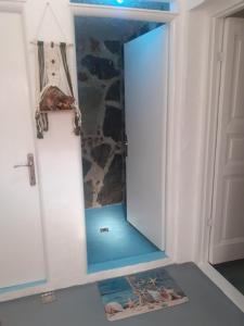 a cabinet with a mirror in a room at Stone House Rooms near Kavala in Amisianá