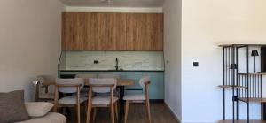 a kitchen with a table and chairs in a room at Villa Castro in Ulcinj
