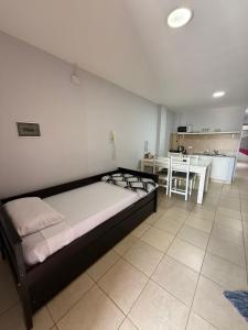 a bedroom with a bed and a kitchen with a table at Apartamentos La Posta in San Salvador de Jujuy