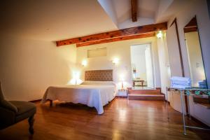 a bedroom with a white bed in a room at Castellu Rossu in Lucciana