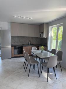 a kitchen with a table and chairs in a kitchen at Садиба Меланія in Svityazʼ