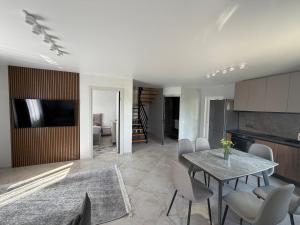 a kitchen and dining room with a table and chairs at Садиба Меланія in Svityazʼ