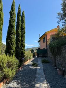 a row of trees in front of a house at B&B Al Bricco in Albisola Superiore +3 photos
