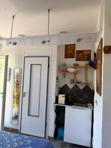 a room with a door and a kitchen with a counter at B&B Al Bricco in Albisola Superiore