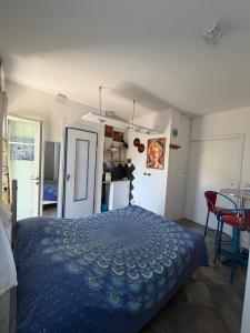 a bedroom with a bed and a table with chairs at B&B Al Bricco in Albisola Superiore