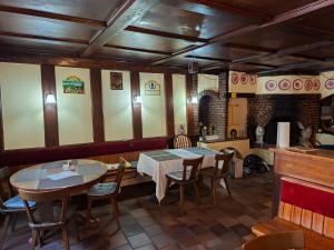 a dining room with a table and a fireplace at Braui Pub and Restaurant in Waldenburg
