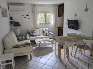 a living room with a couch and a table at Les Mayombes in Roquebrune-sur-Argens