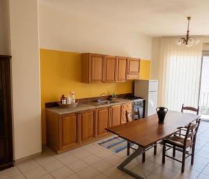 a kitchen with a wooden table and a table and a dining room at SteLuRe in Aradeo