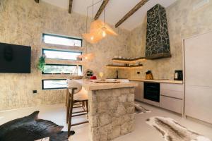 a kitchen with a stone counter and a kitchen island at Eden's Garden Villa in Ulcinj