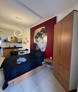 a bedroom with a bed with a painting on the wall at Modern and fully equipped studios in Bosque, downtown area in Rio Branco +99 photos