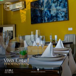a dining room table with plates and wine glasses at Hotel DPanda House in Luanda