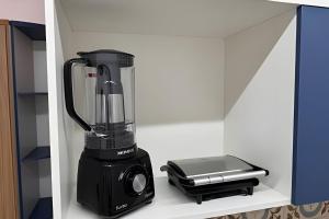 a blender sitting on top of a shelf at Modern and fully equipped studios in Bosque, downtown area in Rio Branco