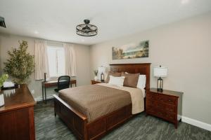 a bedroom with a bed and a desk at Manitoulin Inn in Mindemoya